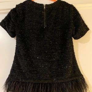 Sparkly black top with feather detail